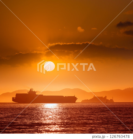 Alcatraz island penitentiary at sunset and merchant ship 126763478