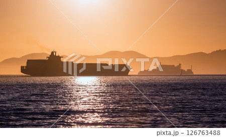Alcatraz island penitentiary at sunset and merchant ship Alcatraz island penitentiary at sunset and merchant ship 126763488