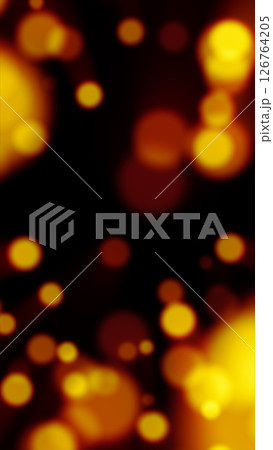 Glowing yellow particles float across a dark background in a vibrant bokeh-style abstract scene 126764205