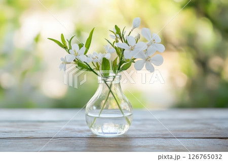 White flowers in a vase on wood table 126765032