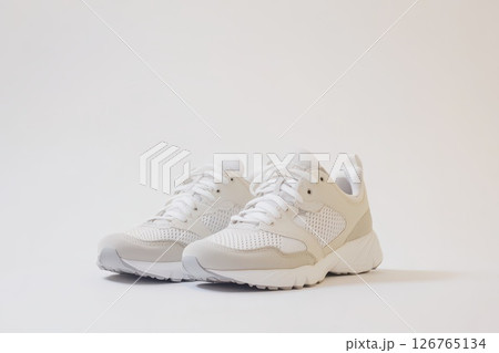 White athletic sneakers on a plain background 126765134