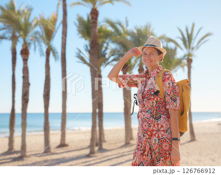 Woman strolls through colorful streets of Spanish coastal town 126766912