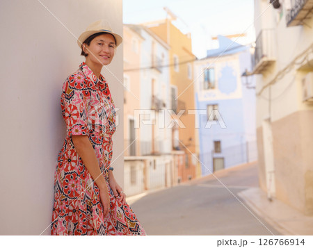 Woman strolls through colorful streets of Spanish coastal town 126766914