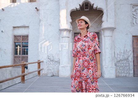 Young female tourist exploring iconic landmarks of the United Arab Emirates. 126766934
