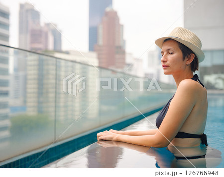 Young woman relaxing by the pool at a Kuala Lumpur hotel 126766948