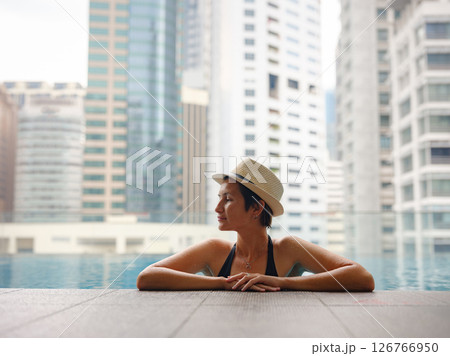 Young woman relaxing by the pool at a Kuala Lumpur hotel 126766950