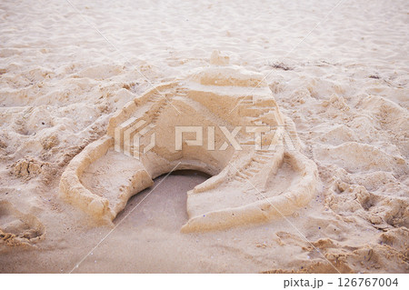 built sand castle on the sea coast 126767004