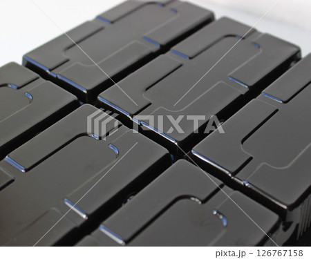Rectangular Slots On A Black Glossy Plastic Panel Rectangular Slots On A Black Glossy Plastic Panel 126767158