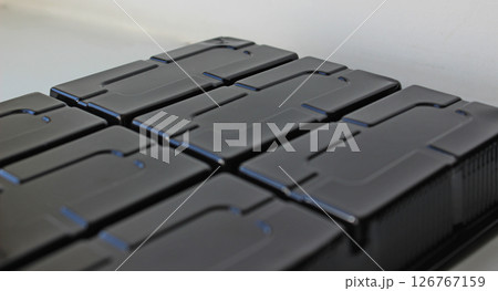 Abstract background of black plastic panel with rectangular slots Abstract background of black plastic panel with rectangular slots 126767159