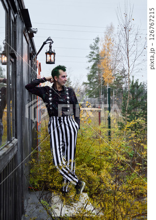 A Fashionable and Stylish Individual Dressed in Striped Pants and Sporting Vibrant Green Hair A Fashionable and Stylish Individual Dressed in Striped Pants and Sporting Vibrant Green Hair 126767215