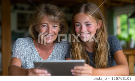 Grandmother and Granddaughter Using Digital Tablet 126768102