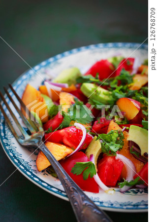 Fresh spring salad witn avocado, tomato, peach, red onion and herbs 126768709