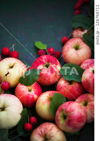 Fresh ripe colorful apples on green rustic background Fresh ripe colorful apples on green rustic background 126768713