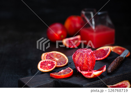 Fresh ripe red blood oranges (sicilian) on dark background Fresh ripe red blood oranges (sicilian) on dark background 126768719