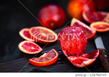 Fresh ripe red blood oranges (sicilian) on dark background Fresh ripe red blood oranges (sicilian) on dark background 126768720