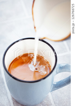 Hot black americano coffee and pouring milk 126768725
