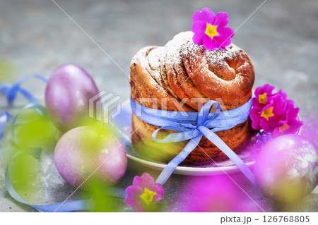 Sweet Easter bread, panettone or cruffin and colorful painted eggs, Holiday spring concept Sweet Easter bread, panettone or cruffin and colorful painted eggs, Holiday spring concept 126768805