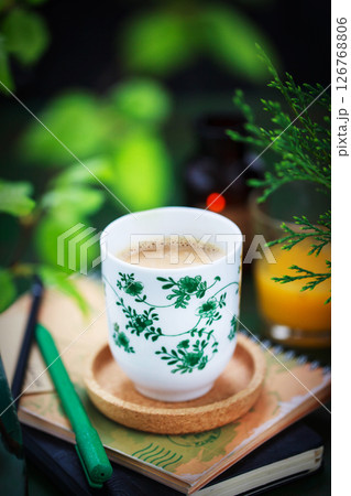 Cozy ceramic cup of cofee on spring background Cozy ceramic cup of cofee on spring background 126768806