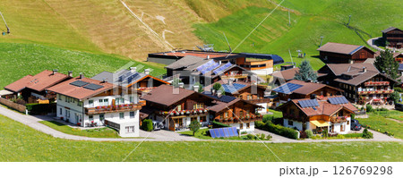 Scenic aerial alpine view austrian mountain village Kals am Grossglockner valley green rural farmland meadow horse pasture background. Austria Alp osttirol National park nature. Summer hiking tourism Scenic aerial alpine view austrian mountain village Kals am Grossglockner valley green rural farmland meadow horse pasture background. Austria Alp osttirol National park nature. Summer hiking tourism 126769298