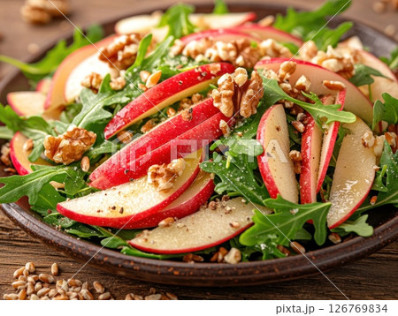 Delicious apple and walnut salad on a rustic plate Delicious apple and walnut salad on a rustic plate 126769834