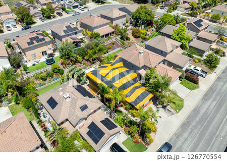 Yellow and gray termite tent on a big house in South California Yellow and gray termite tent on a big house in South California 126770554