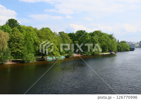 A Tranquil Riverside Scene Embraced by Lush, Greenery and Natures Beauty All Around A Tranquil Riverside Scene Embraced by Lush, Greenery and Natures Beauty All Around 126770996
