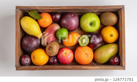 Fruits in a wooden box on white surface 126771781