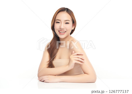 A beautiful young Asian woman with clean, fresh skin against a white background. Skincare, facial treatment, cosmetology, beauty, and spa. An elegant portrait of an Asian woman. 126777137