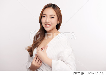 A beautiful young Asian woman with clean, fresh skin against a white background. Skincare, facial treatment, cosmetology, beauty, and spa. An elegant portrait of an Asian woman. A beautiful young Asian woman with clean, fresh skin against a white background. Skincare, facial treatment, cosmetology, beauty, and spa. An elegant portrait of an Asian woman. 126777144