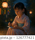 七夕の夜、短冊に願いを書く浴衣姿の少女（願い・希望） 126777421
