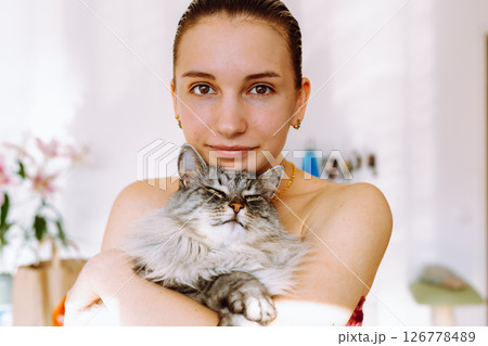 Portrait young woman with pet cat Portrait young woman with pet cat 126778489