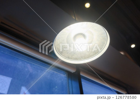 飲食店の天井ライトと窓辺のインテリア風景 126778580