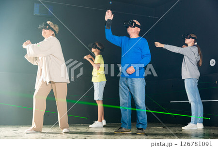 Young boy and girl playing VR games with grandparents Young boy and girl playing VR games with grandparents 126781091