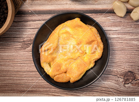 The Thai style omelet on wood table for Thai food  concept. 126781885