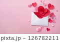 Love letter overflowing with paper hearts on pink background 126782211