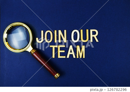 Join Our Team alphabet letters with magnifying glass on navy blue background Join Our Team alphabet letters with magnifying glass on navy blue background 126782296