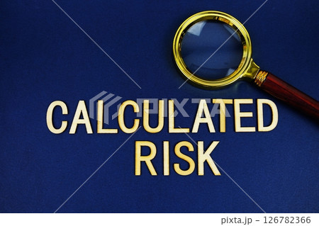 Assess Risk alphabet letters with magnifying glass on navy blue background Assess Risk alphabet letters with magnifying glass on navy blue background 126782366