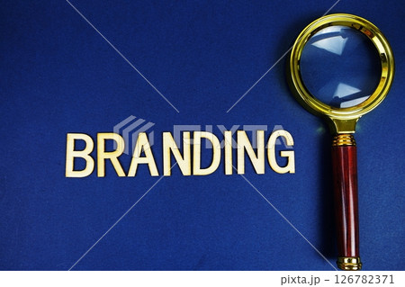 Branding alphabet letters with magnifying glass on navy blue background 126782371