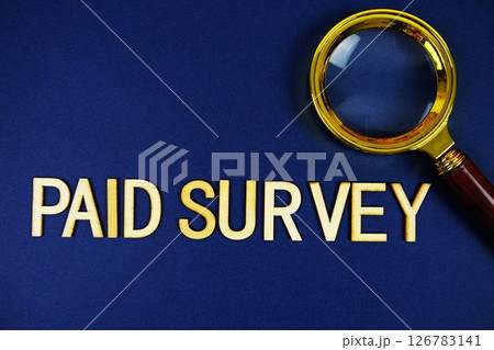 Paid Survey alphabet letters with magnifying glass on navy blue background 126783141