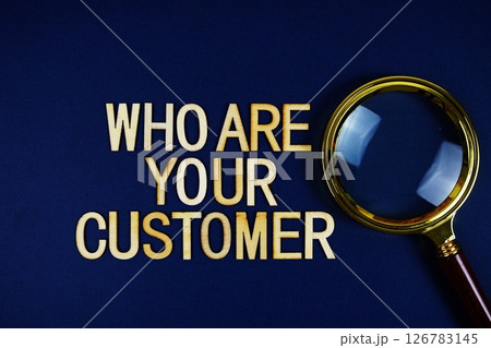 Who Are Your Customer? alphabet letters with magnifying glass on navy blue background 126783145