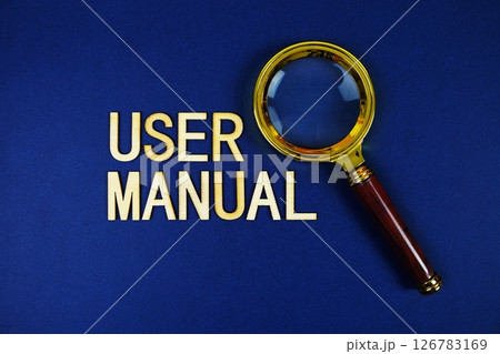 User Manual alphabet letters with magnifying glass on navy blue background User Manual alphabet letters with magnifying glass on navy blue background 126783169