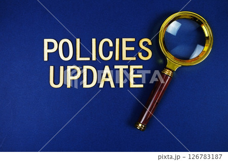 Policies Update alphabet letters with magnifying glass on navy blue background Policies Update alphabet letters with magnifying glass on navy blue background 126783187