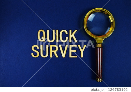 Quick Survey alphabet letters with magnifying glass on navy blue background Quick Survey alphabet letters with magnifying glass on navy blue background 126783192