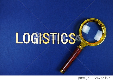 Logistics alphabet letters with magnifying glass on navy blue background Logistics alphabet letters with magnifying glass on navy blue background 126783197