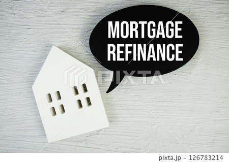 Mortgage Refinance text message on speech bubble with house model on concrete background Mortgage Refinance text message on speech bubble with house model on concrete background 126783214