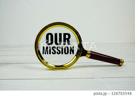Our mission text with magnifying glass on wooden background 126783548