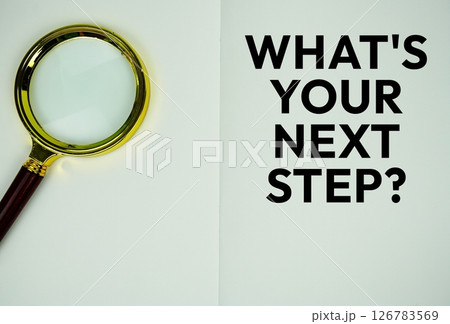 What is your next step? text message written on note page with magnifying glass 126783569