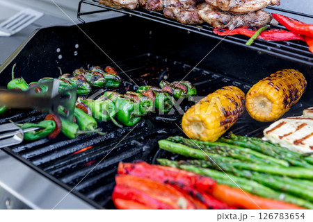 Grilling chicken, corn cobs, paprika, padron, asparagus. Grilling chicken, corn cobs, paprika, padron, asparagus. 126783654