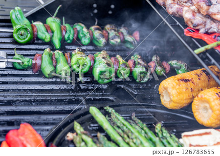 Grilling chicken, corn cobs, paprika, padron, asparagus. Grilling chicken, corn cobs, paprika, padron, asparagus. 126783655