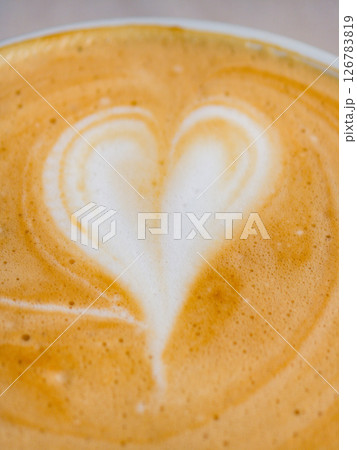 Delicious coffee with a heart design crafted in a cozy cafe setting Delicious coffee with a heart design crafted in a cozy cafe setting 126783819